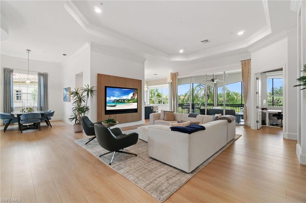 17010 Porta Vecchio Way, Unit 201 Naples, FL 34110 - Photo 2 of 50 a living room with fireplace furniture and a flat screen tv
