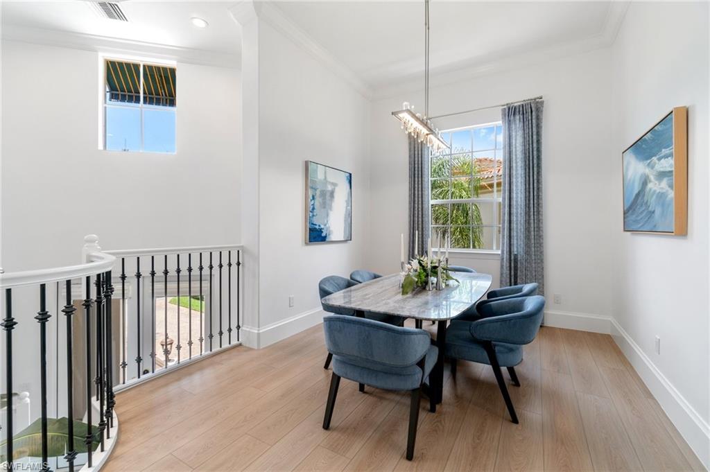 17010 Porta Vecchio Way, Unit 201 Naples, FL 34110 - Photo 4 of 50 a view of a dining room with furniture window and wooden floor