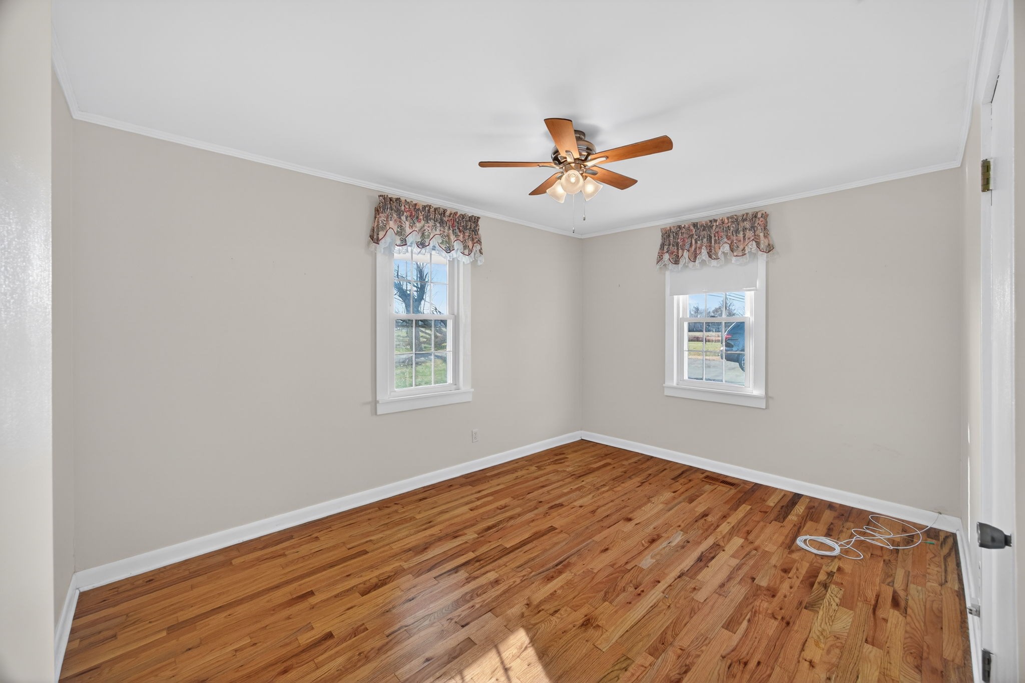 716 Dry Creek Road Smithville, TN 37166 - Photo 16 of 31 a view of empty room with wooden floor and fan