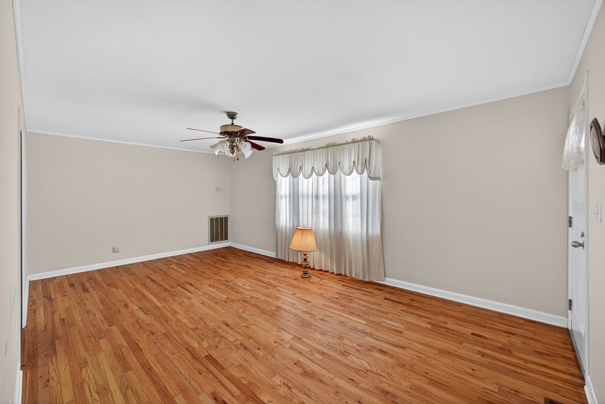 716 Dry Creek Road Smithville, TN 37166 - Photo 2 of 31 a view of empty room with wooden floor and fan