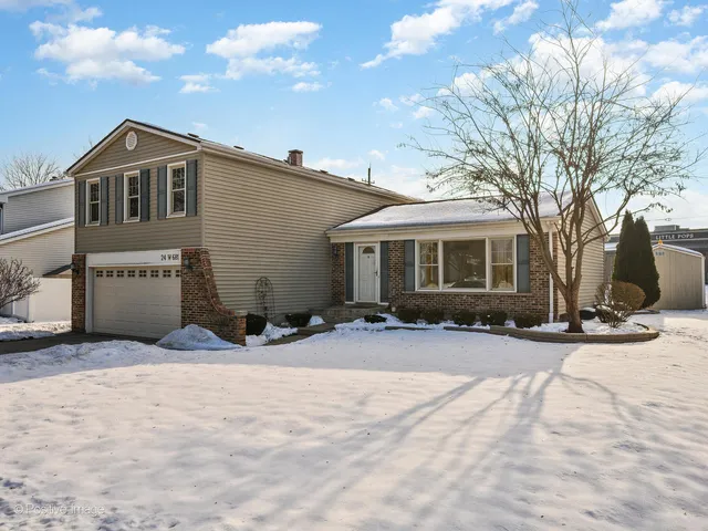 a view of a house with snow on the road