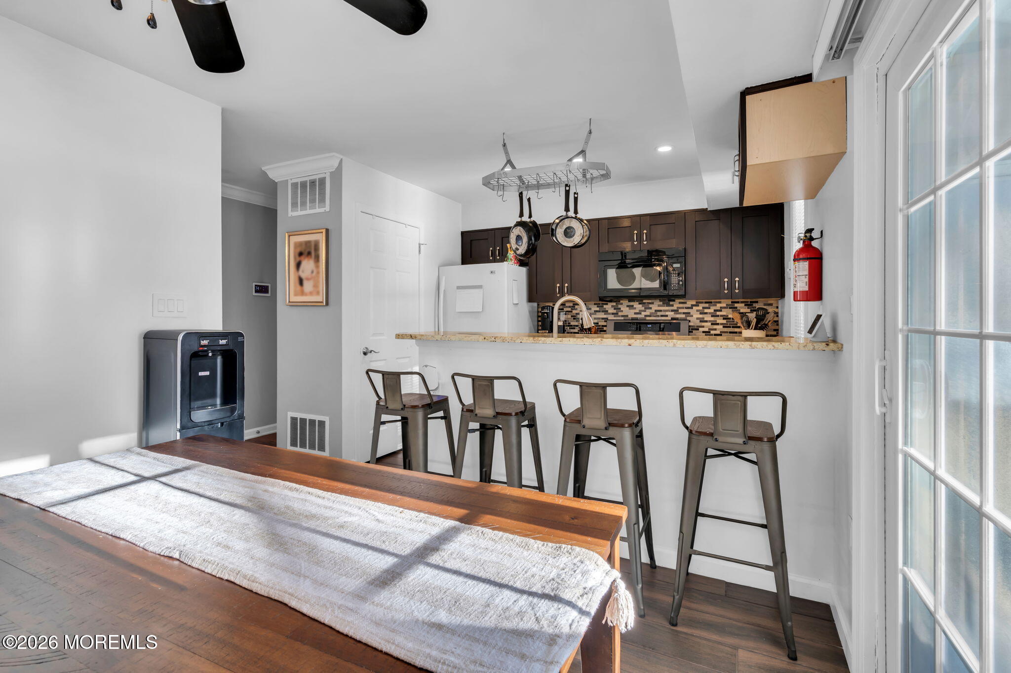 4 Duncan Way Freehold, NJ 07728 - Photo 13 of 28 a kitchen with stainless steel appliances granite countertop a stove a sink and a refrigerator with wooden floor
