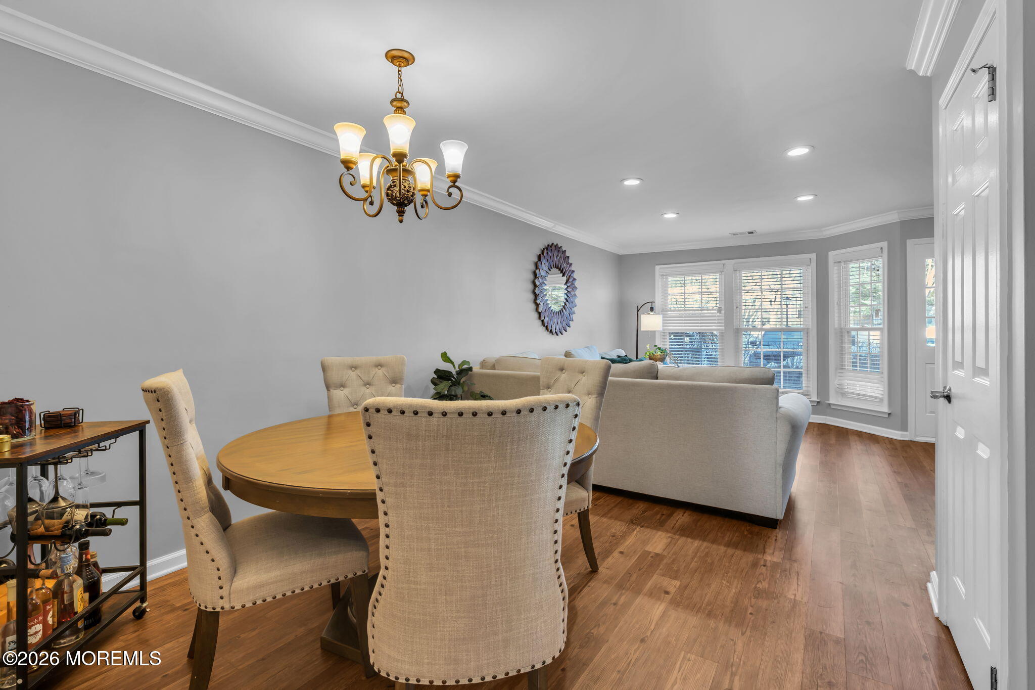 4 Duncan Way Freehold, NJ 07728 - Photo 10 of 28 a living room with a dining table wooden floor and a chandelier
