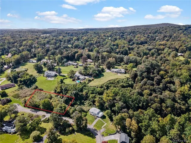 an aerial view of a houses with a yard