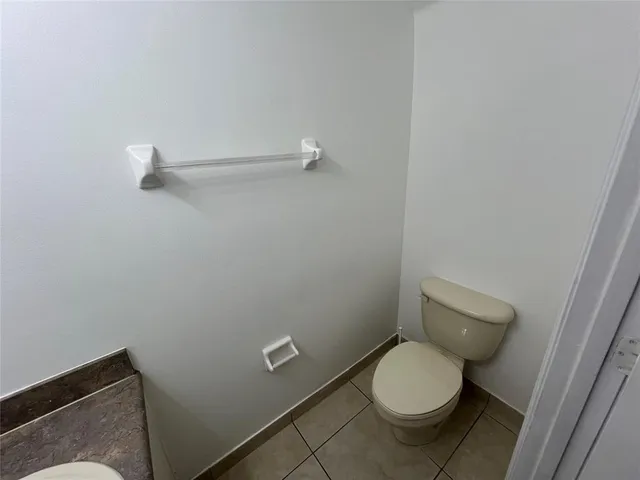 a white toilet sitting in a bathroom