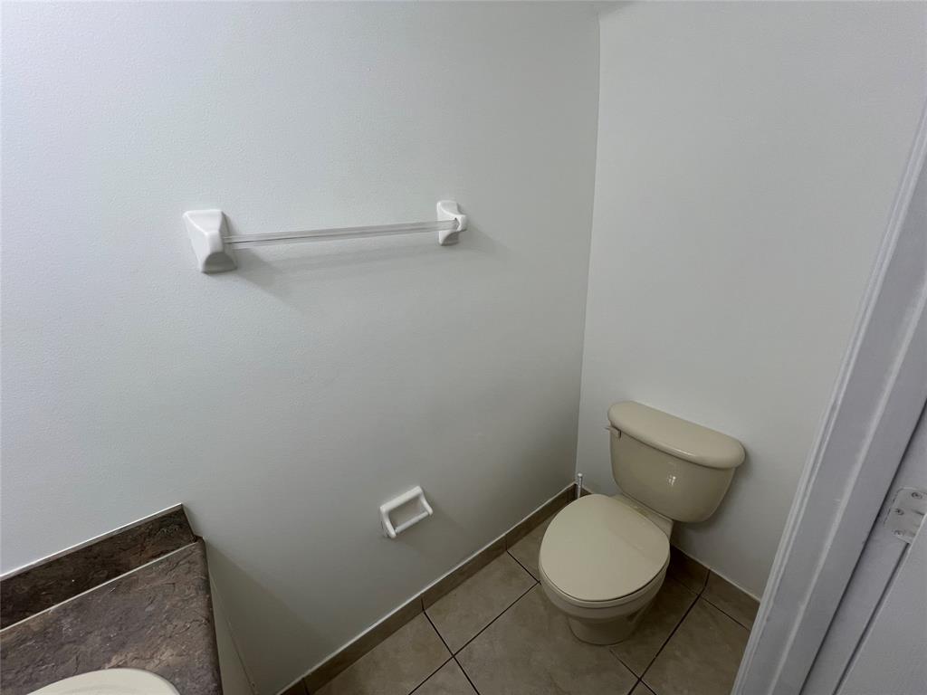 6756 Sienna Club Drive, Unit 6756 Lauderhill, FL 33319 - Photo 12 of 24 a white toilet sitting in a bathroom