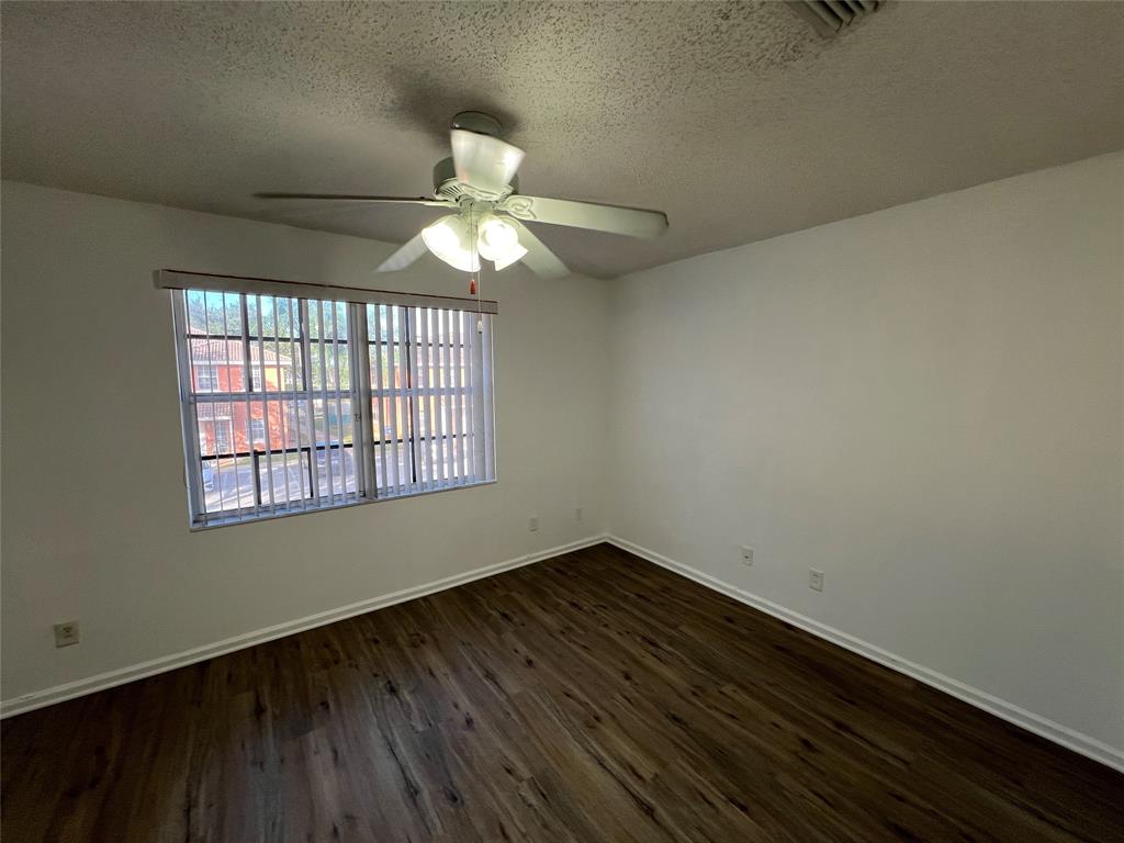 6756 Sienna Club Drive, Unit 6756 Lauderhill, FL 33319 - Photo 17 of 24 an empty room with wooden floor fan and windows