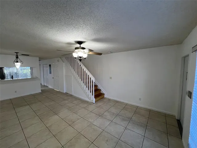 a view of a livingroom with a furniture and chandelier fan