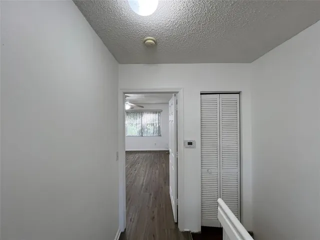 a view of hallway with wooden floor