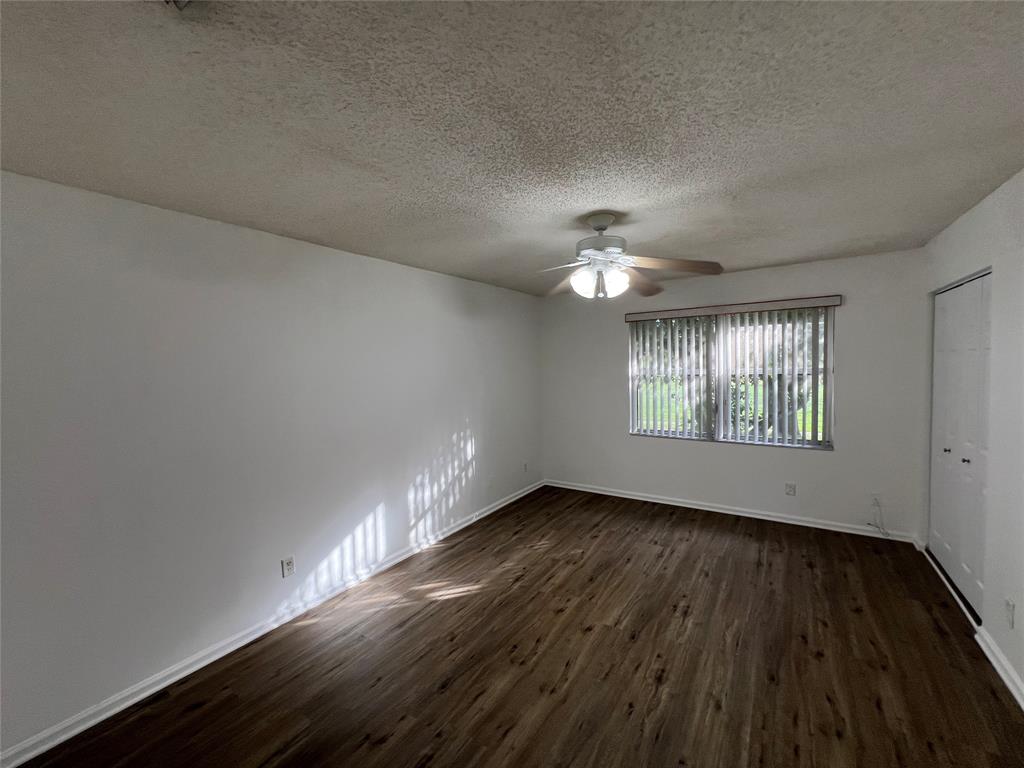 6756 Sienna Club Drive, Unit 6756 Lauderhill, FL 33319 - Photo 22 of 24 a view of an empty room with wooden floor and a window
