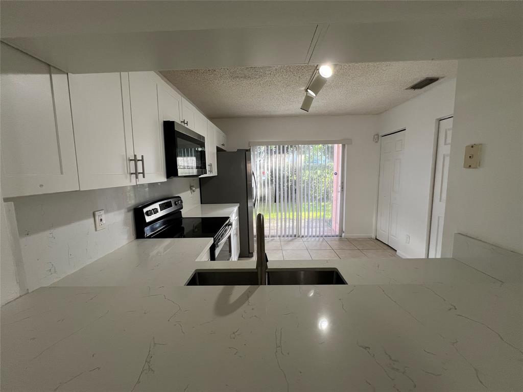 6756 Sienna Club Drive, Unit 6756 Lauderhill, FL 33319 - Photo 6 of 24 a view of a room with gym equipment