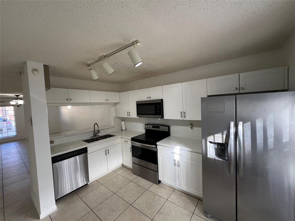 6756 Sienna Club Drive, Unit 6756 Lauderhill, FL 33319 - Photo 7 of 24 a kitchen with a refrigerator and a stove top oven