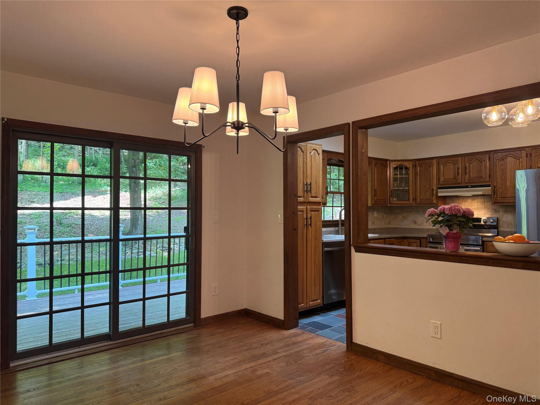687 Sprout Brook Road Putnam Valley, NY 10579 - Photo 11 of 45 Dining Room with Hard Wood Floors, Sliding glass doors leading to the back deck and a cut out to the kitchen