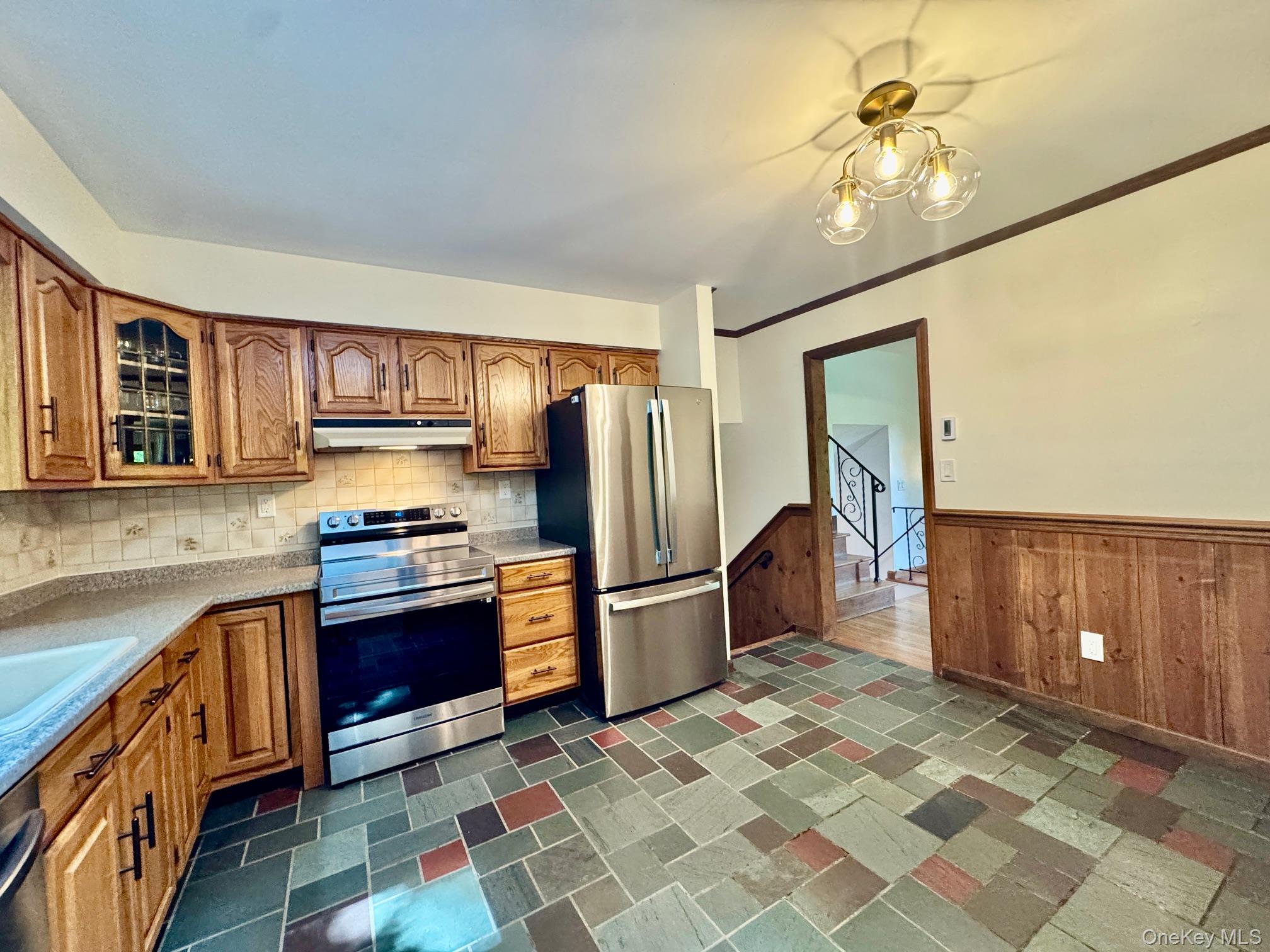 687 Sprout Brook Road Putnam Valley, NY 10579 - Photo 14 of 45 a kitchen with stainless steel appliances granite countertop a refrigerator and a stove top oven
