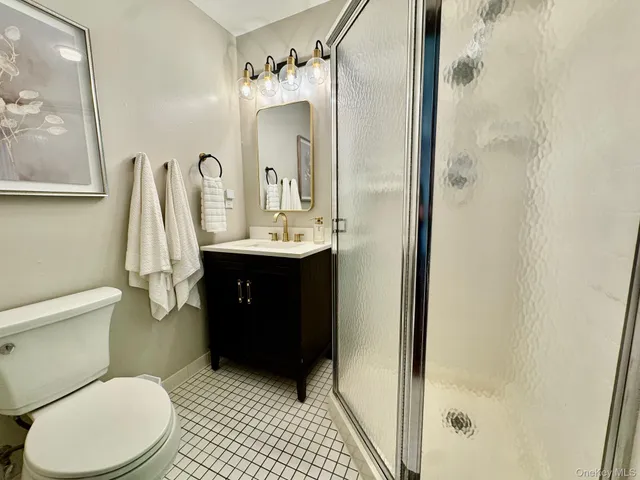 a view of an empty room with a fireplace and window