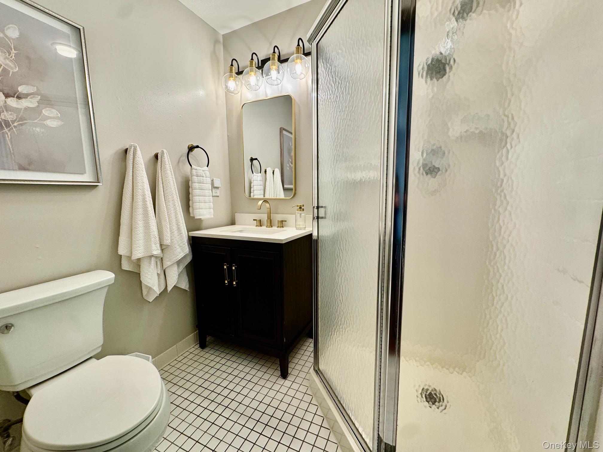 687 Sprout Brook Road Putnam Valley, NY 10579 - Photo 17 of 45 a bathroom with a sink a toilet and shower