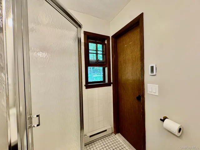 a bathroom with a toilet a sink and a mirror