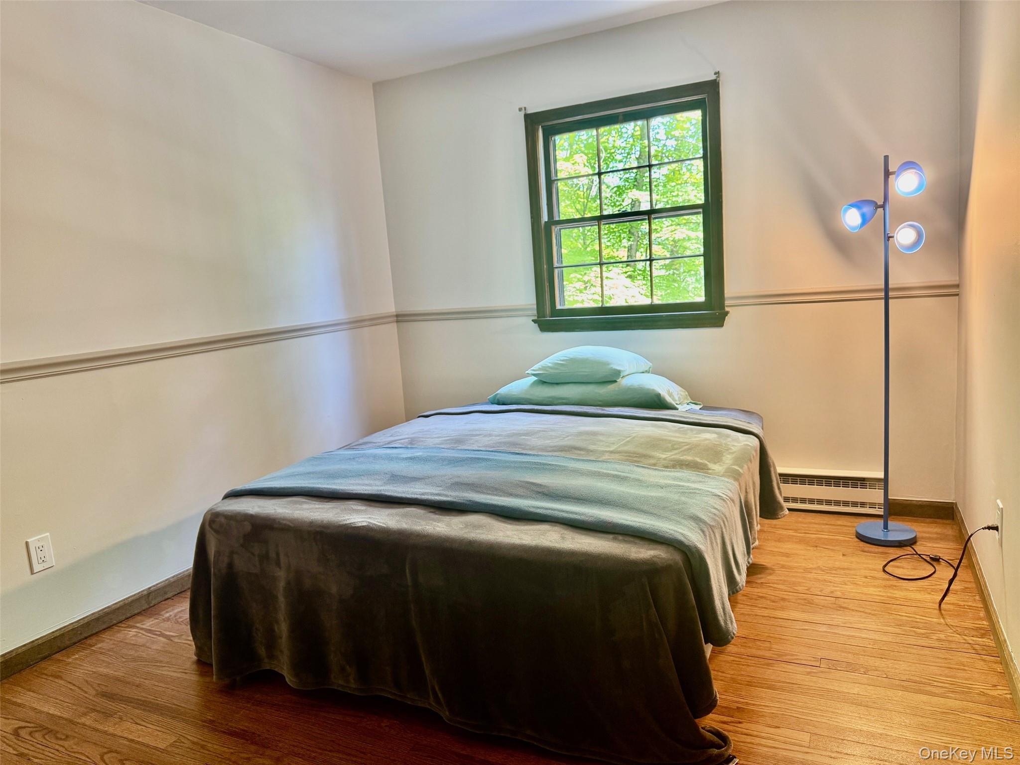 687 Sprout Brook Road Putnam Valley, NY 10579 - Photo 19 of 45 a bedroom with a bed and a window