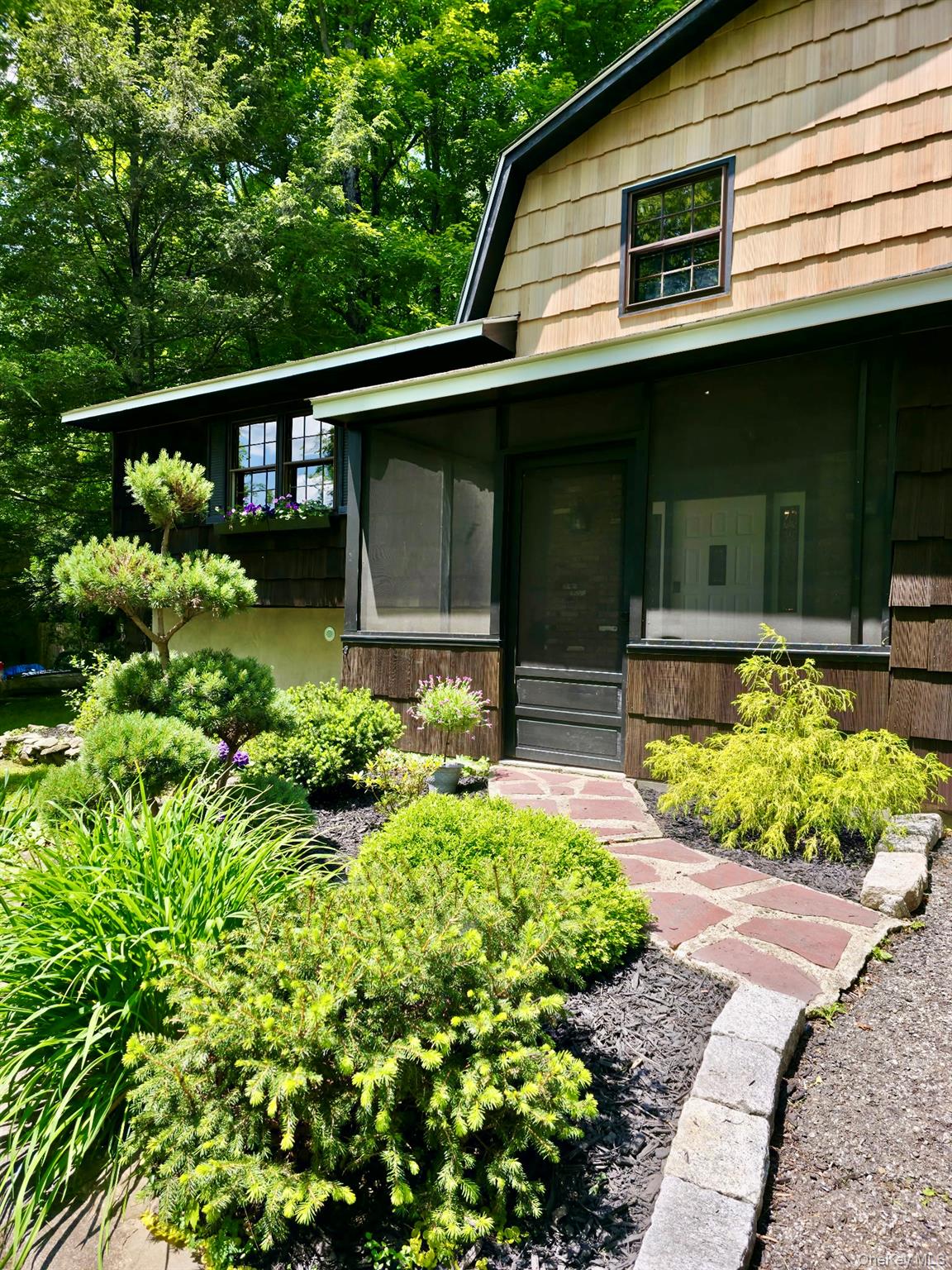 687 Sprout Brook Road Putnam Valley, NY 10579 - Photo 2 of 45 a front view of a house with a yard