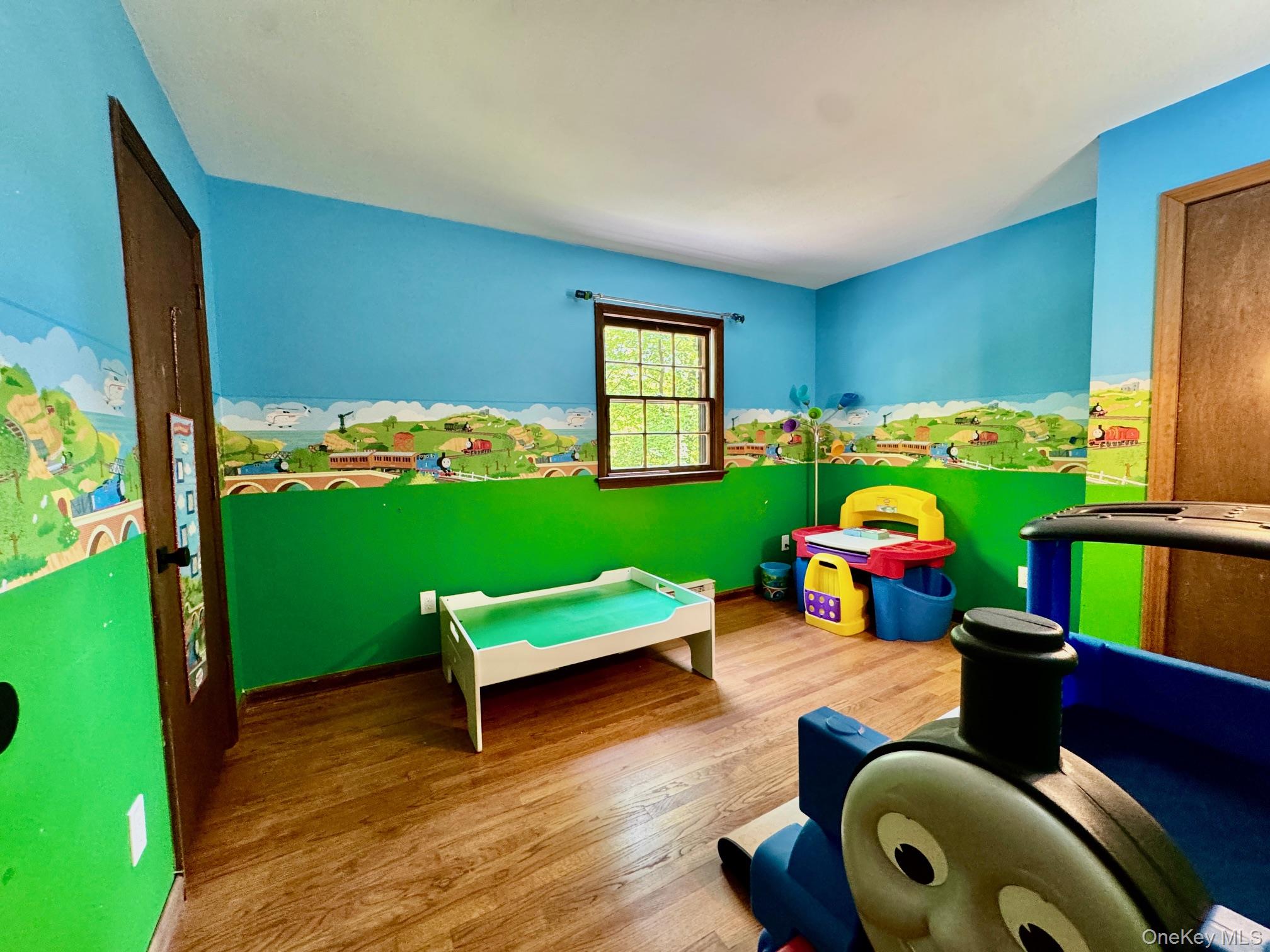 687 Sprout Brook Road Putnam Valley, NY 10579 - Photo 23 of 45 a room with toys and a wooden floor