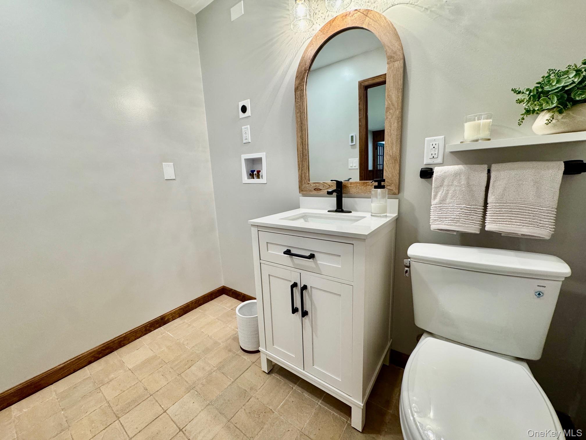 687 Sprout Brook Road Putnam Valley, NY 10579 - Photo 27 of 45 a bathroom with a toilet sink and mirror