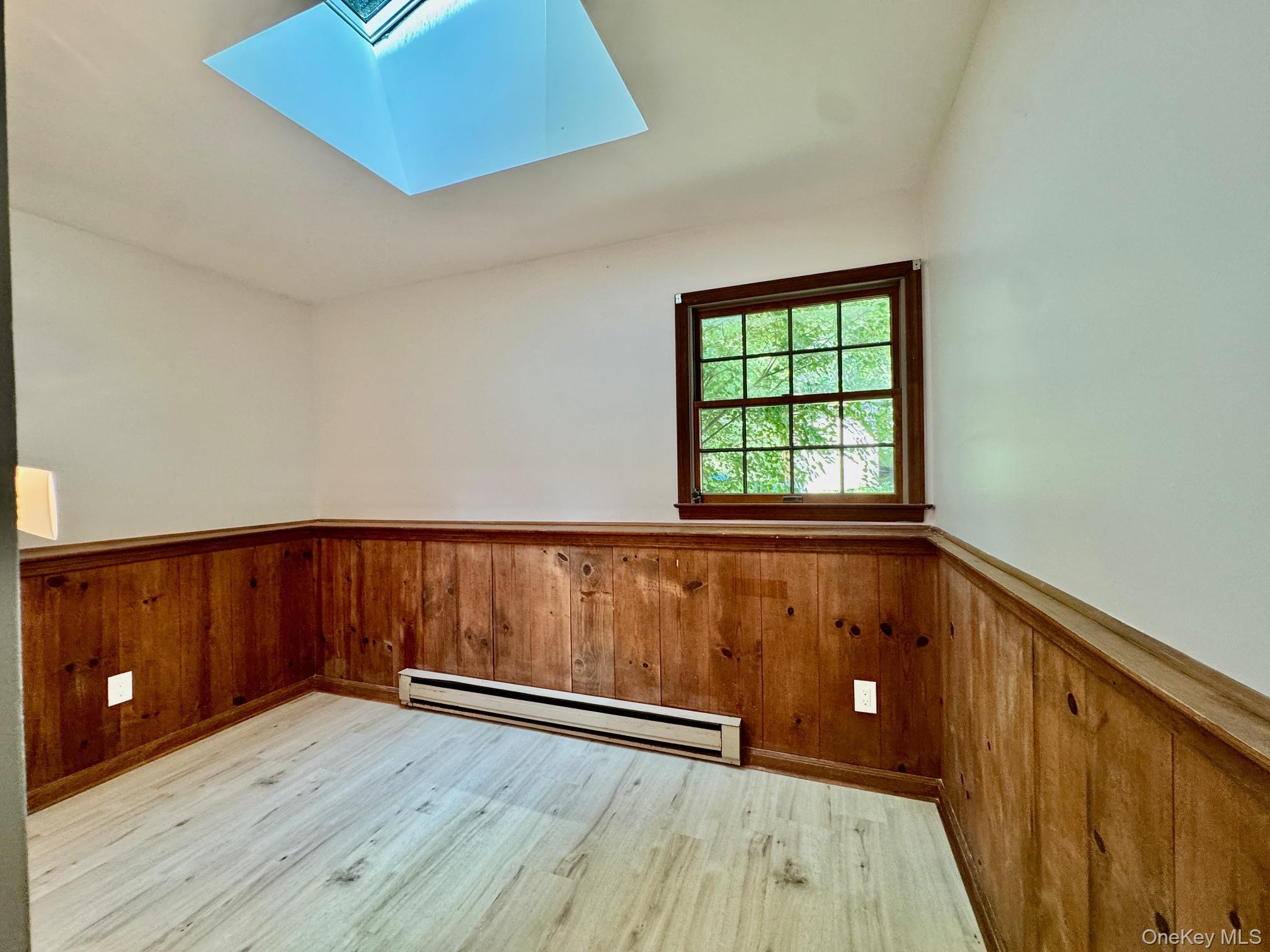 687 Sprout Brook Road Putnam Valley, NY 10579 - Photo 29 of 45 a view of wooden floor and windows in a room