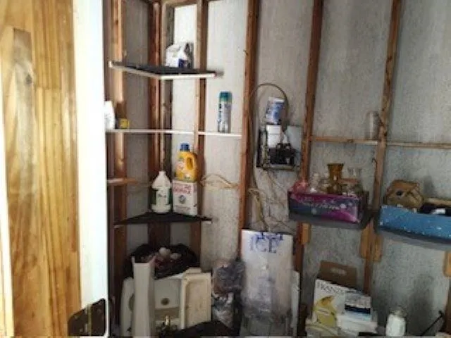 a view of living room with furniture and clutter