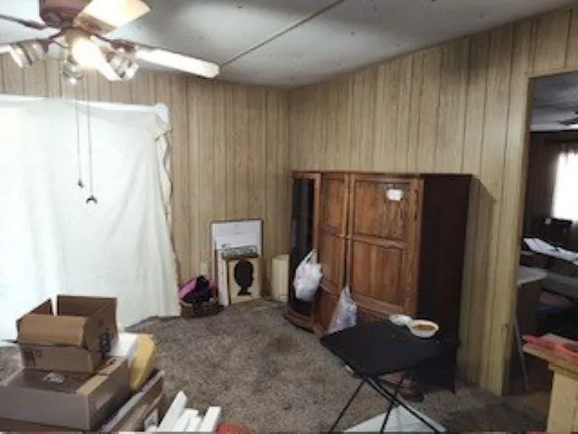 a living room with furniture a desk and chair with wooden floor
