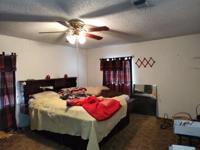 a bedroom with bed and a chandelier