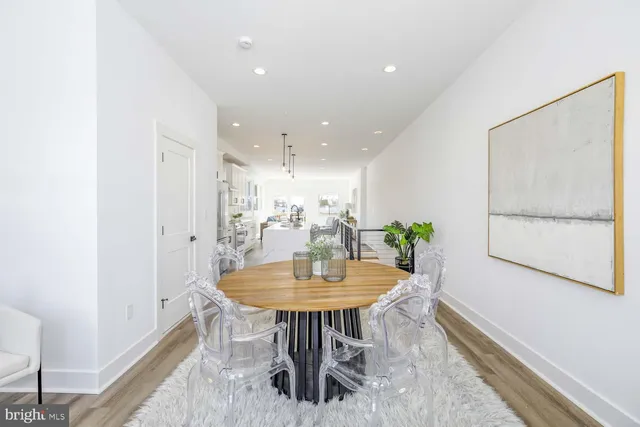 a view of a dining room with furniture and a potted plant