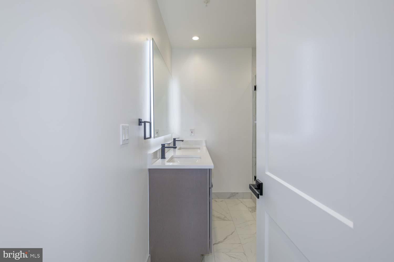 424 Taylor Street Northwest, Unit B Washington, DC 20011 - Photo 27 of 51 a bathroom with a sink and mirror