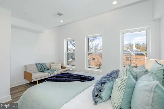 a bedroom with a bed couch and window