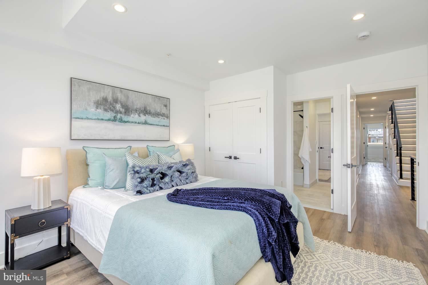 424 Taylor Street Northwest, Unit B Washington, DC 20011 - Photo 35 of 51 a spacious bedroom with a bed and a lamp