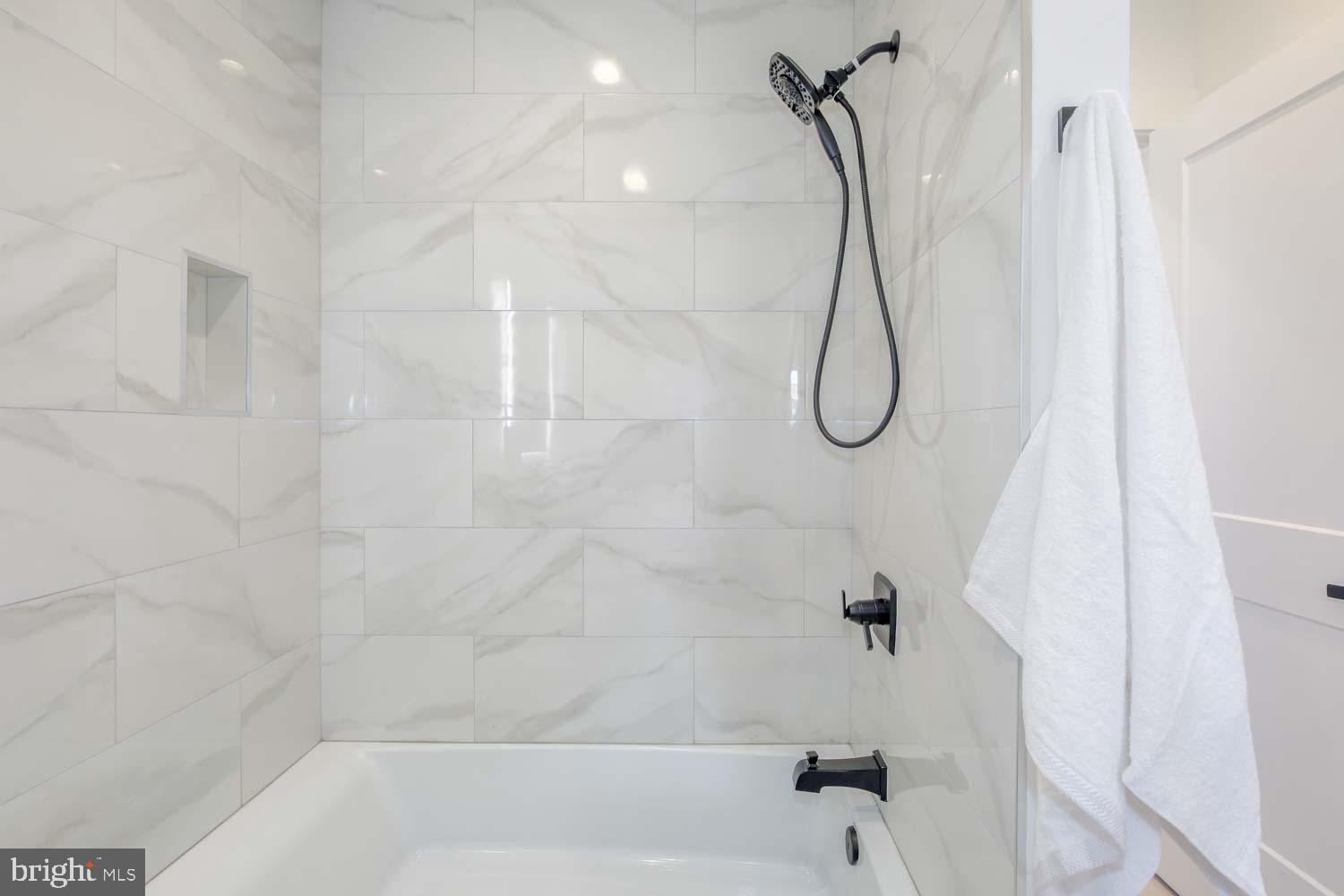 424 Taylor Street Northwest, Unit B Washington, DC 20011 - Photo 39 of 51 a bathroom with a bath tub with a shower