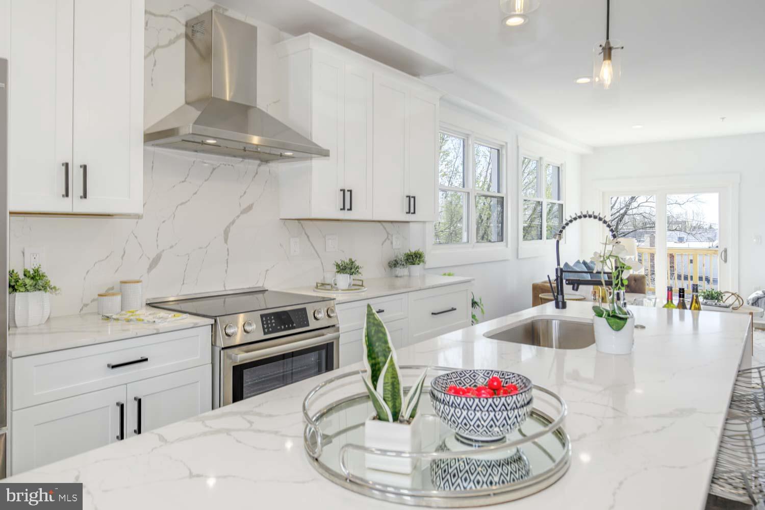 424 Taylor Street Northwest, Unit B Washington, DC 20011 - Photo 6 of 51 a kitchen with granite countertop stainless steel appliances a sink a stove and a wooden floors