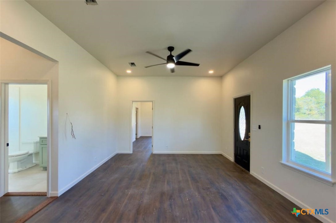 3633 North Katy Road Elm Mott, TX 76640 - Photo 6 of 26 wooden floor in an empty room with a window