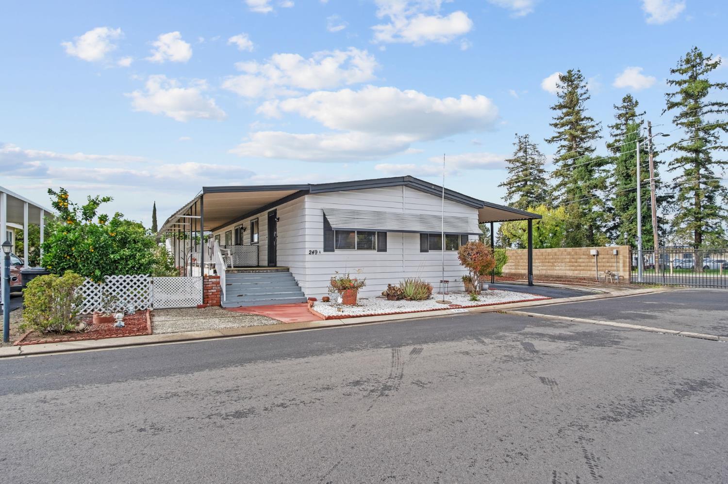 a front view of a house with a yard and potted plants