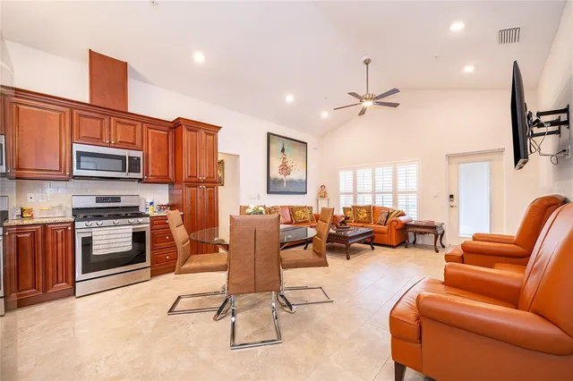 a living room with furniture a kitchen island with furniture and a kitchen view