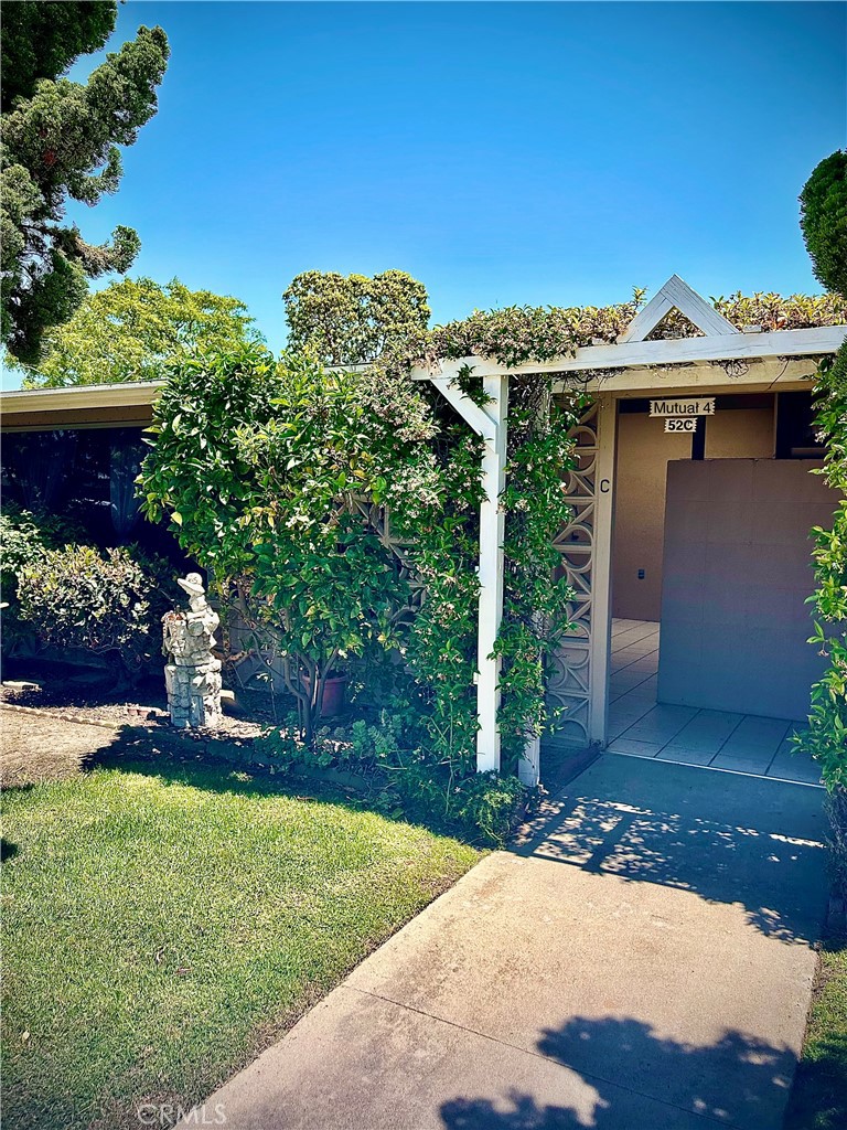 a view of a house with a yard and a garden