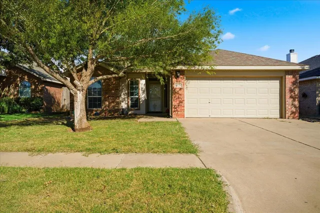 a view of a house with garage and yard