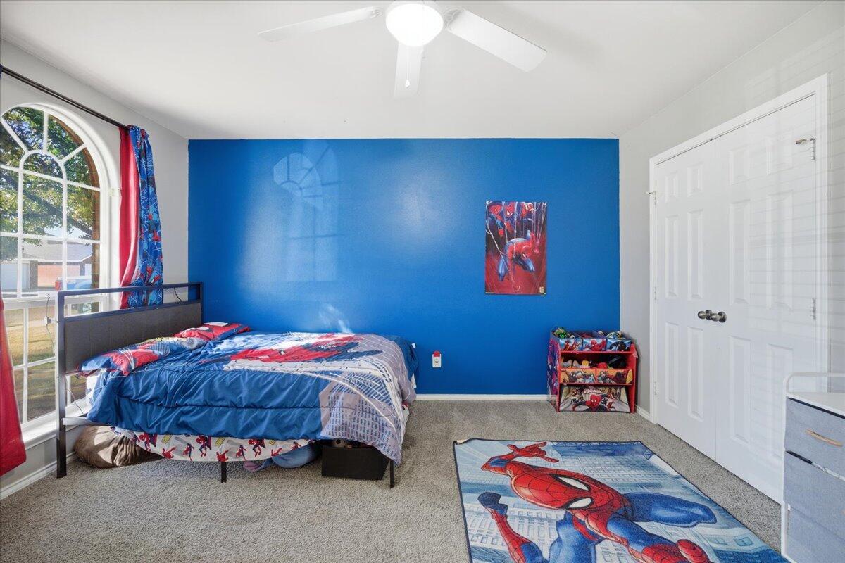 6538 93rd Street Lubbock, TX 79424 - Photo 23 of 27 a bedroom with a bed and a window