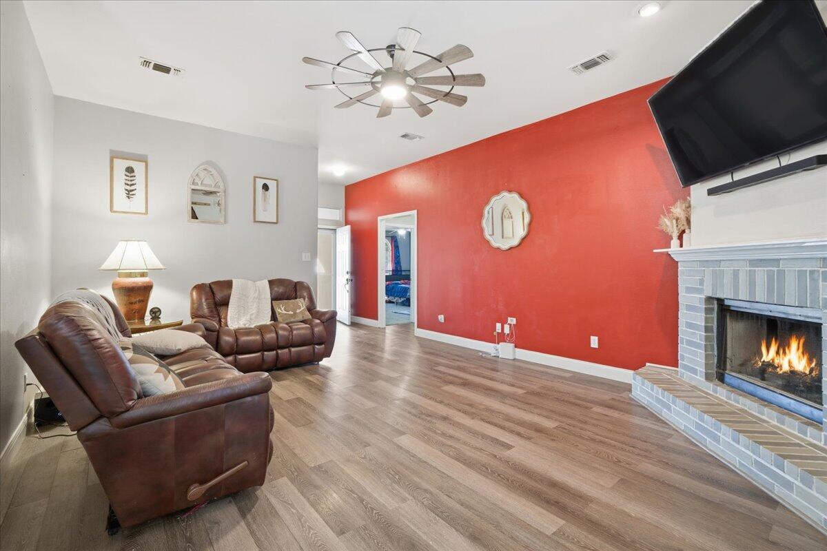 6538 93rd Street Lubbock, TX 79424 - Photo 6 of 27 a living room with furniture fireplace and a flat screen tv