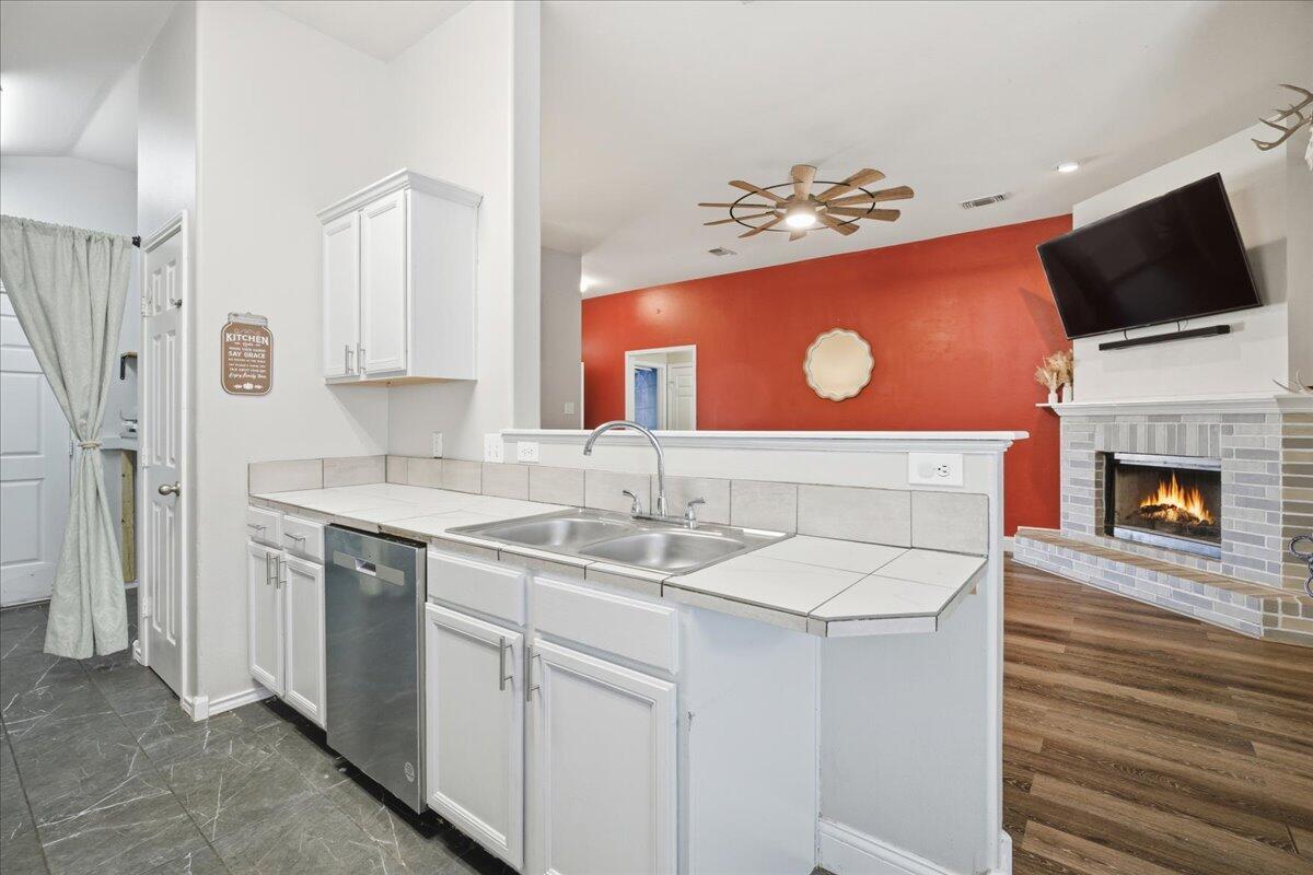 6538 93rd Street Lubbock, TX 79424 - Photo 9 of 27 a kitchen with a sink stove and microwave