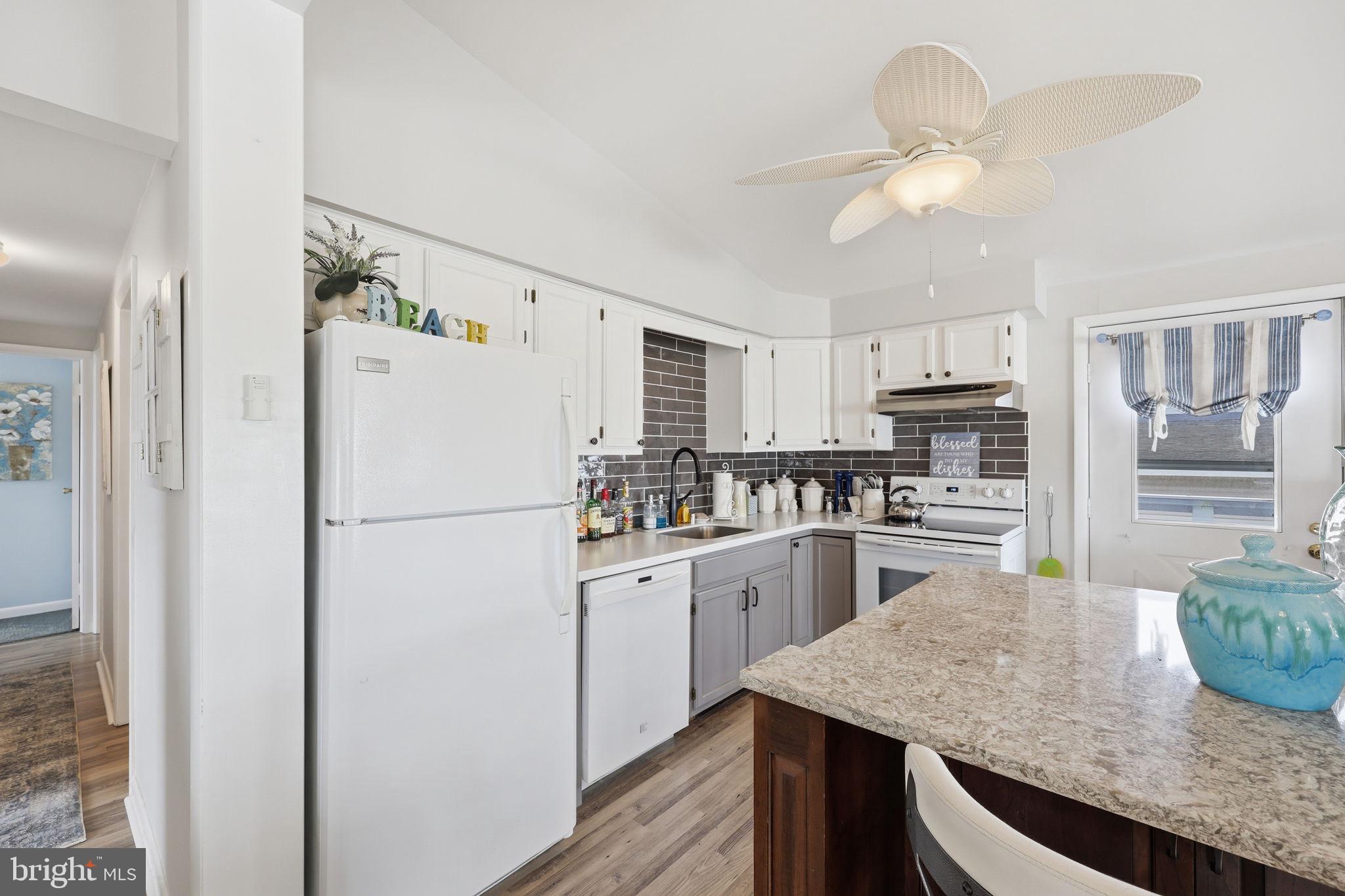 173 Cove Road Newport, NJ 08345 - Photo 12 of 72 a kitchen with a refrigerator a stove a microwave and island