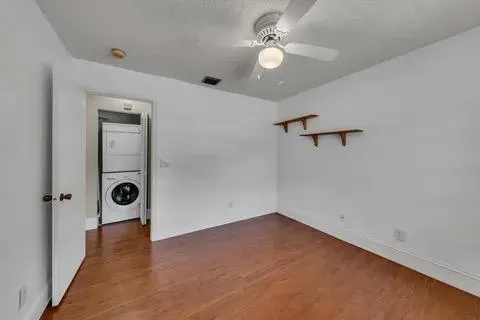 wooden floor in an empty room and a window