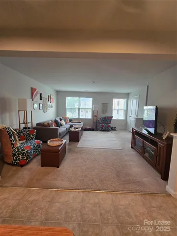 a living room with furniture fireplace and window