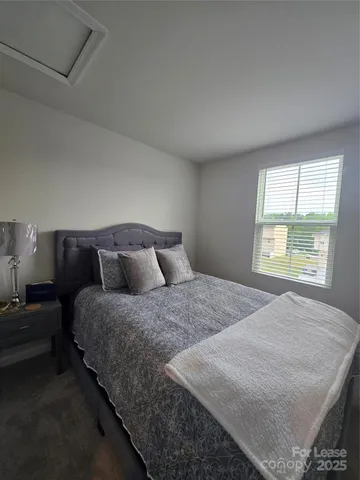 a bedroom with bed and window