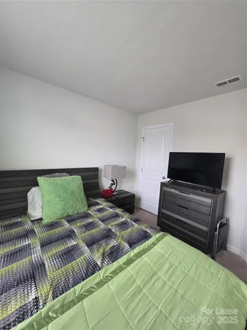 a bedroom with two beds and a couch