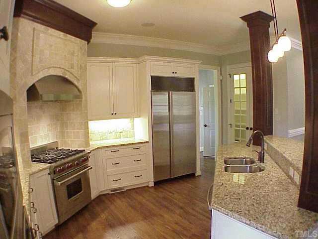 3324 Thomas Road Raleigh, NC 27607 - Photo 6 of 12 a kitchen with stainless steel appliances granite countertop a stove a sink and a refrigerator