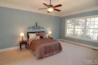 3324 Thomas Road Raleigh, NC 27607 - Photo 7 of 12 a bedroom with a bed and a chandelier fan
